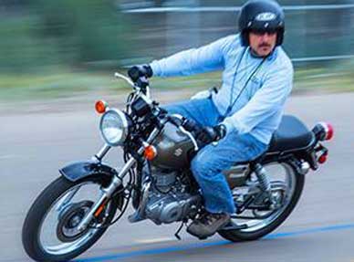 Male riding motorcycle in safety class